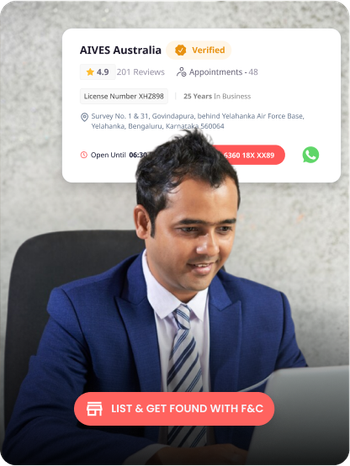 Man in suit using laptop with AIVES Australia verified immigration consultant profile on Find & Consult.